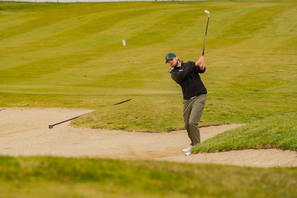 Golfer playing out of a bunker